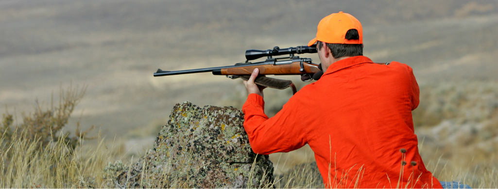 An image of a rifle hunter wearing a blaze orange clothing while hunting in Pennsylvania