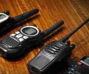 A selection of hunting 2-way radios on a woody surface